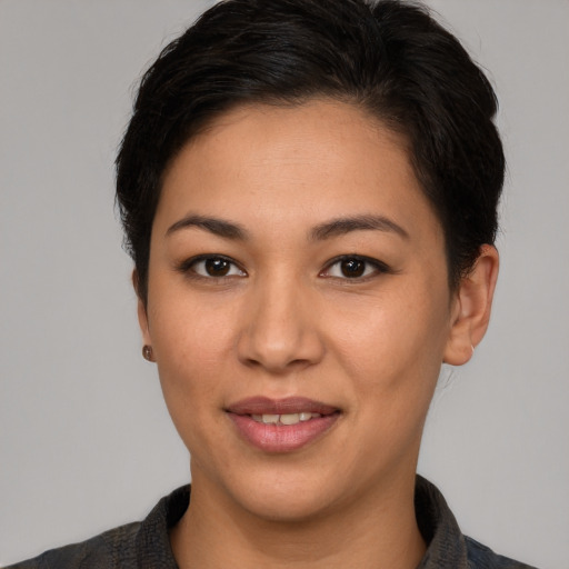 Joyful latino young-adult female with short  brown hair and brown eyes