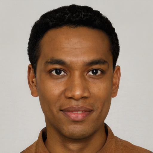 Joyful black young-adult male with short  black hair and brown eyes