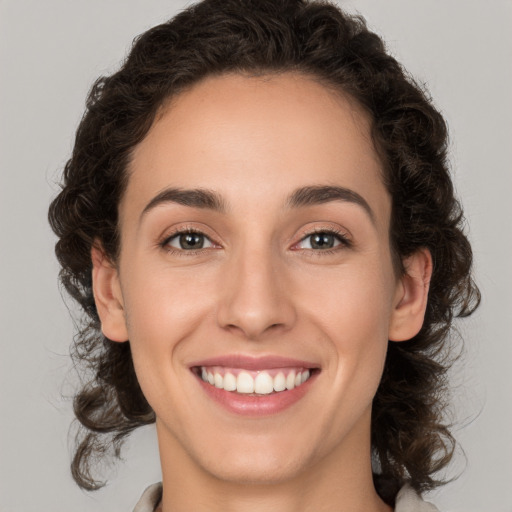 Joyful white young-adult female with medium  brown hair and brown eyes