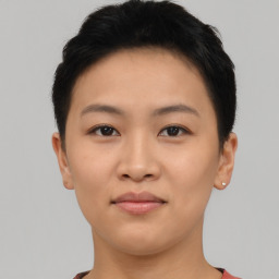 Joyful asian young-adult female with short  brown hair and brown eyes