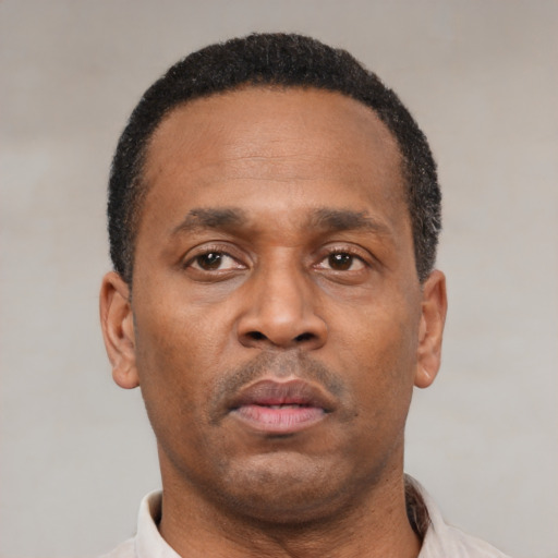 Neutral latino adult male with short  black hair and brown eyes