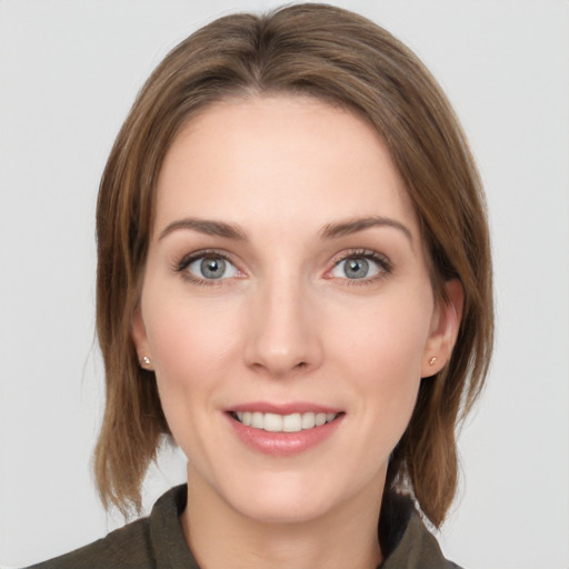 Joyful white young-adult female with medium  brown hair and grey eyes