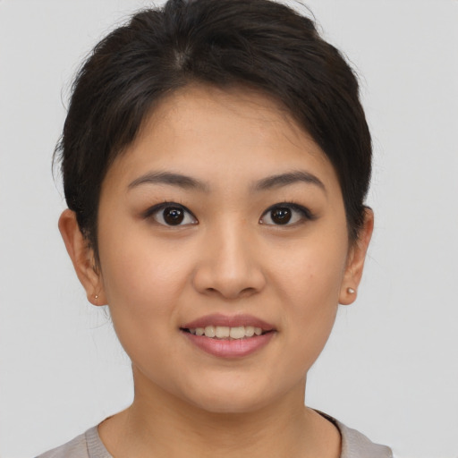Joyful asian young-adult female with short  brown hair and brown eyes