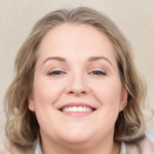 Joyful white young-adult female with medium  brown hair and blue eyes