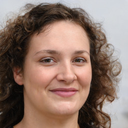 Joyful white adult female with long  brown hair and brown eyes