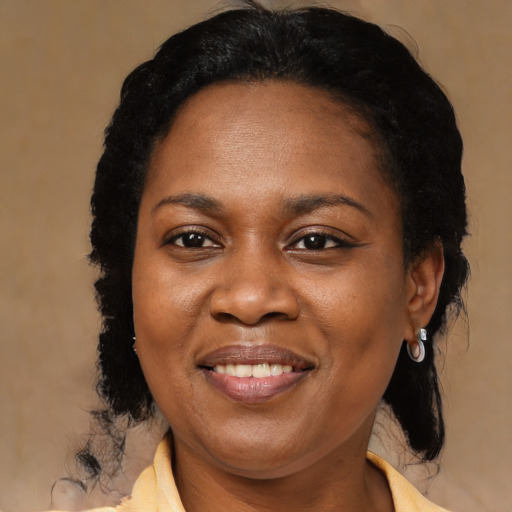 Joyful black adult female with medium  black hair and brown eyes