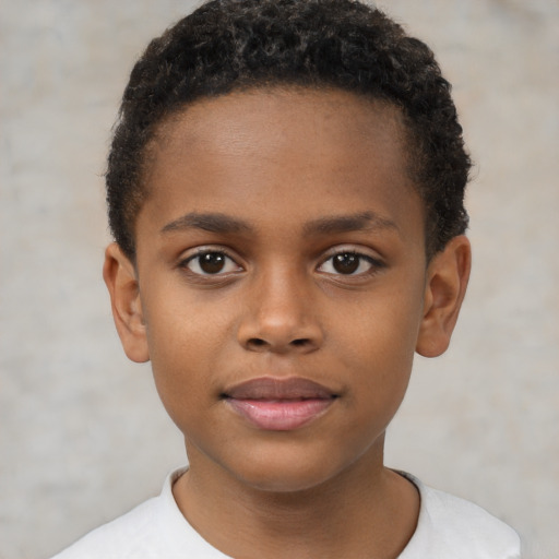 Joyful black child male with short  brown hair and brown eyes