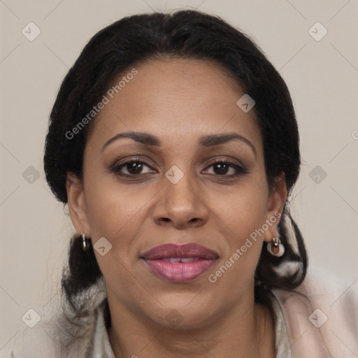 Joyful black adult female with medium  brown hair and brown eyes