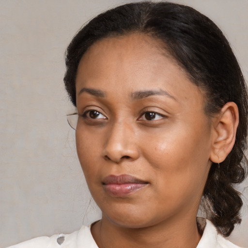 Joyful black young-adult female with medium  brown hair and brown eyes