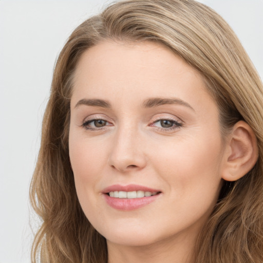 Joyful white young-adult female with long  brown hair and blue eyes