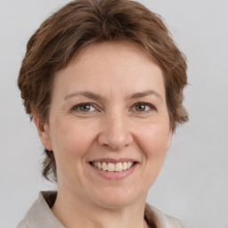 Joyful white adult female with medium  brown hair and grey eyes