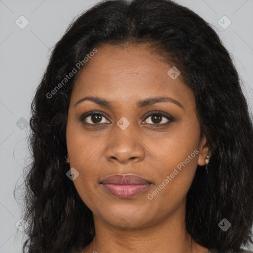 Joyful black young-adult female with long  brown hair and brown eyes