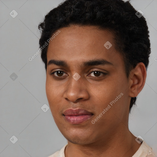 Joyful black young-adult male with short  black hair and brown eyes