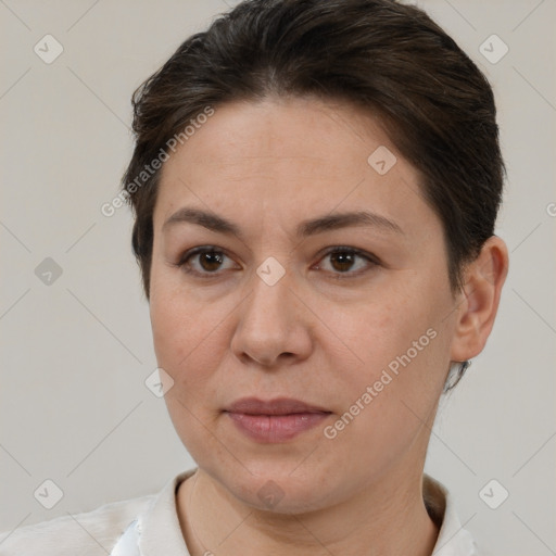 Joyful white adult female with short  brown hair and brown eyes