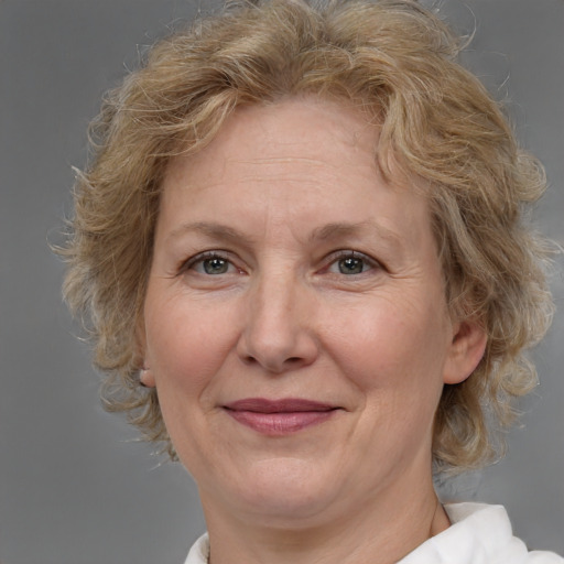 Joyful white middle-aged female with medium  brown hair and brown eyes