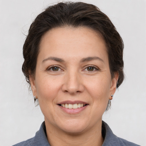Joyful white adult female with medium  brown hair and brown eyes
