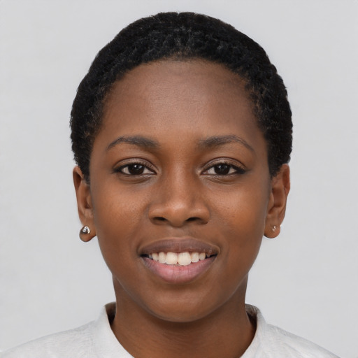 Joyful black young-adult female with short  black hair and brown eyes