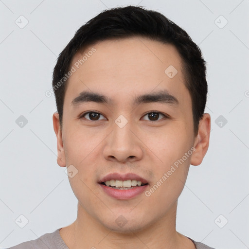 Joyful asian young-adult male with short  black hair and brown eyes