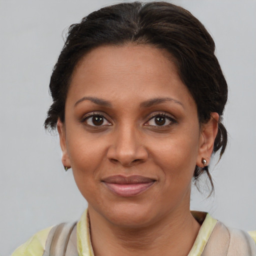 Joyful latino young-adult female with medium  brown hair and brown eyes