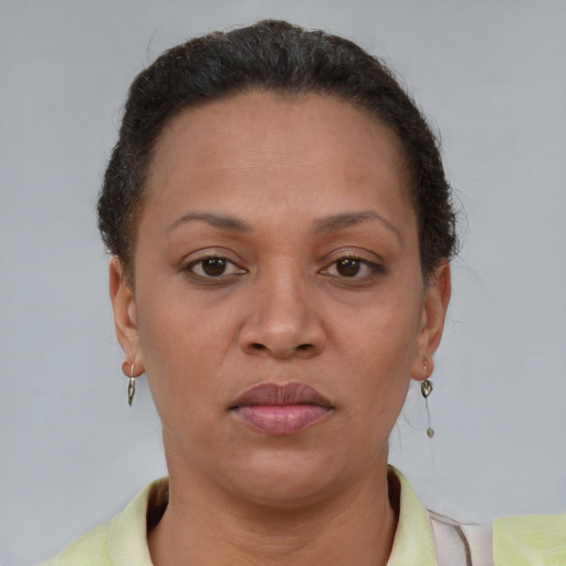Joyful black adult female with short  brown hair and brown eyes