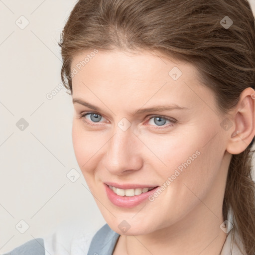 Joyful white young-adult female with medium  brown hair and blue eyes