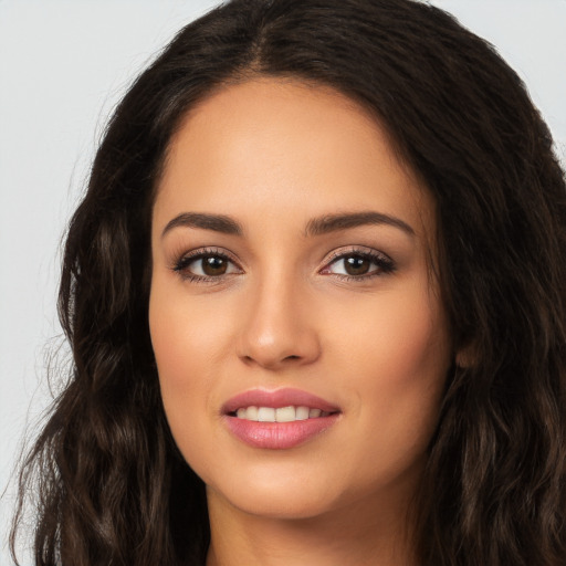 Joyful white young-adult female with long  brown hair and brown eyes