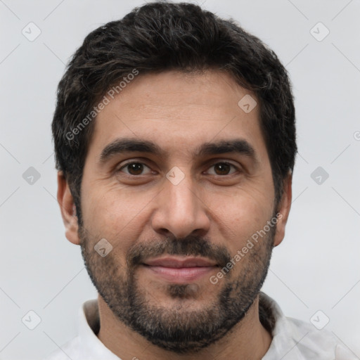 Joyful white young-adult male with short  black hair and brown eyes