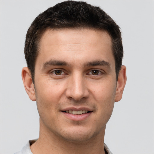 Joyful white young-adult male with short  brown hair and brown eyes