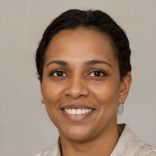 Joyful black young-adult female with short  brown hair and brown eyes