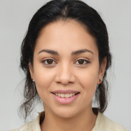 Joyful latino young-adult female with medium  brown hair and brown eyes