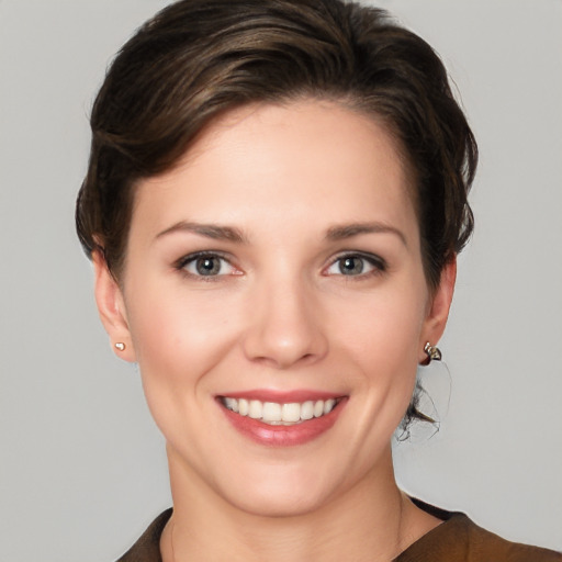 Joyful white young-adult female with short  brown hair and grey eyes