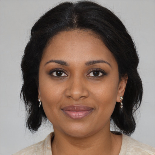 Joyful black young-adult female with medium  brown hair and brown eyes