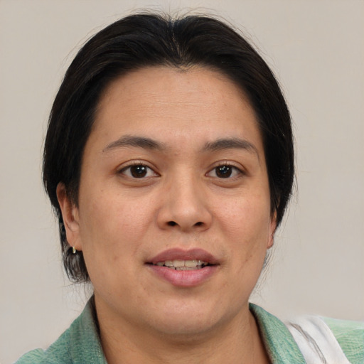 Joyful asian adult female with medium  brown hair and brown eyes