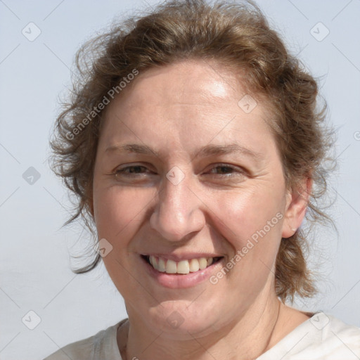 Joyful white adult female with medium  brown hair and blue eyes