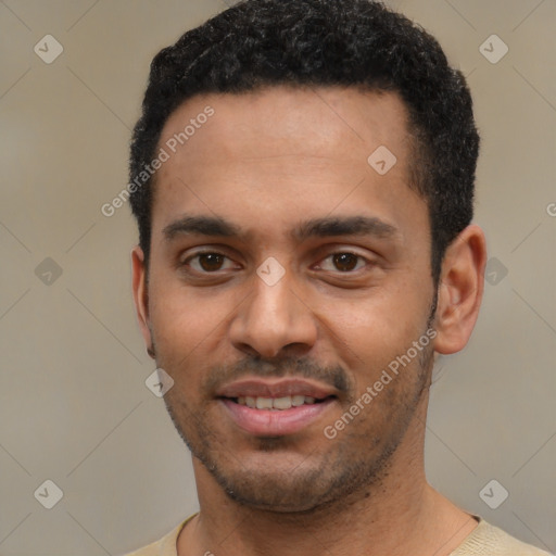 Joyful black young-adult male with short  black hair and brown eyes