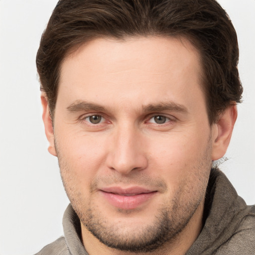 Joyful white young-adult male with short  brown hair and brown eyes