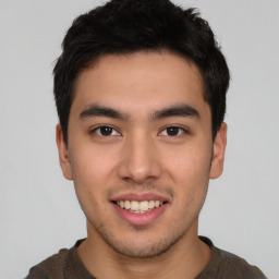 Joyful asian young-adult male with short  brown hair and brown eyes