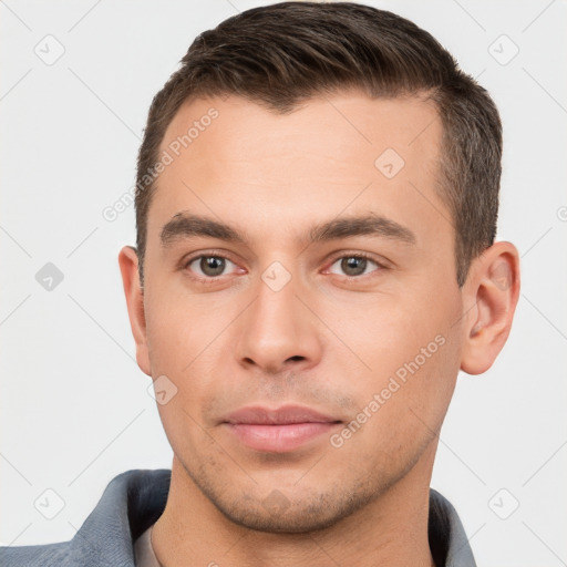 Joyful white young-adult male with short  brown hair and brown eyes