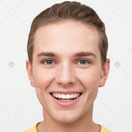 Joyful white young-adult male with short  brown hair and grey eyes