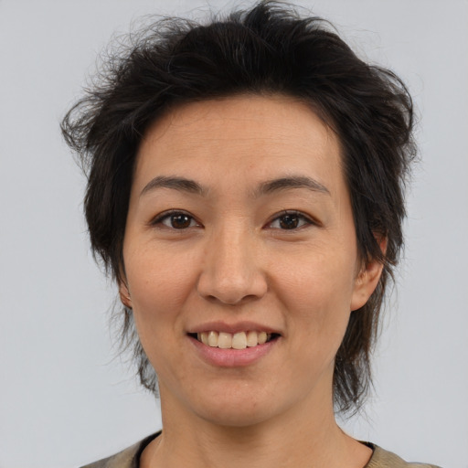 Joyful asian adult female with medium  brown hair and brown eyes