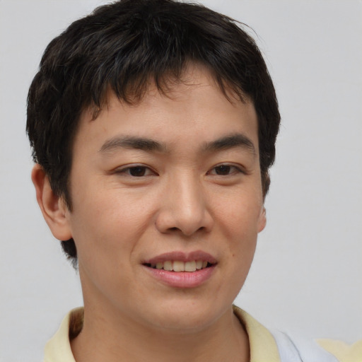 Joyful asian young-adult male with short  brown hair and brown eyes