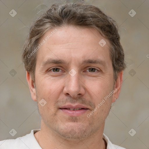 Joyful white adult male with short  brown hair and brown eyes