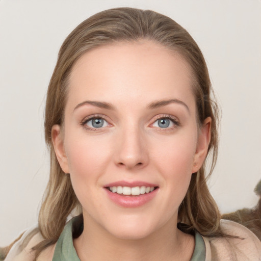 Joyful white young-adult female with medium  brown hair and blue eyes