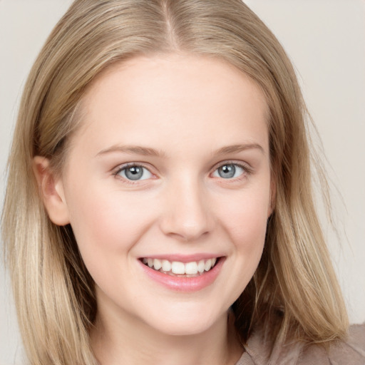 Joyful white young-adult female with long  brown hair and blue eyes