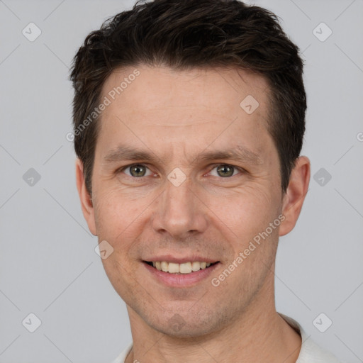 Joyful white adult male with short  brown hair and brown eyes