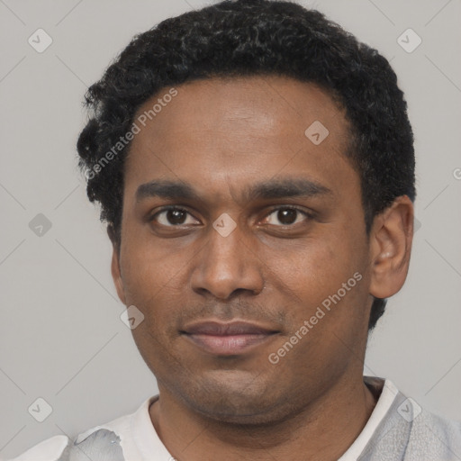 Joyful black young-adult male with short  black hair and brown eyes