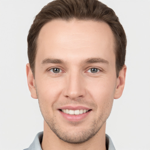 Joyful white young-adult male with short  brown hair and brown eyes