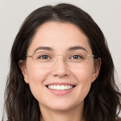 Joyful white young-adult female with long  brown hair and brown eyes