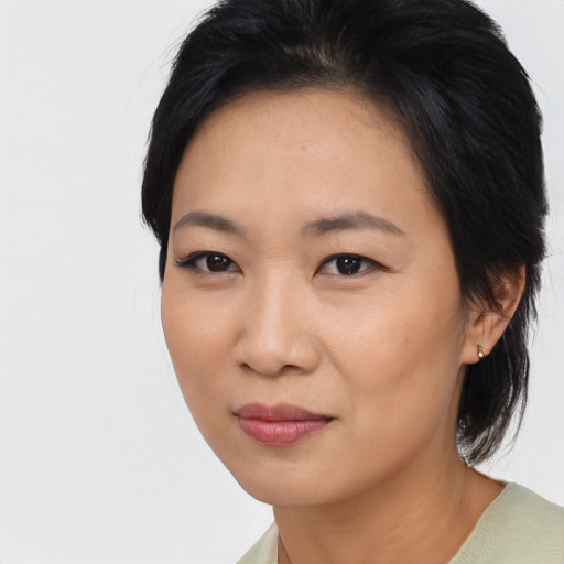 Joyful asian young-adult female with medium  black hair and brown eyes