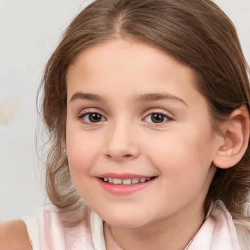 Joyful white child female with medium  brown hair and brown eyes